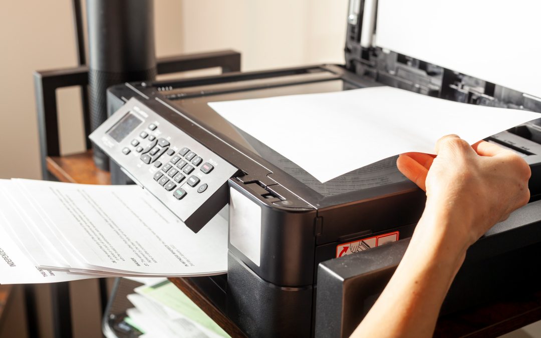 A woman is placing or removing paper.